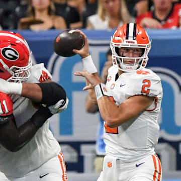 Aug 31, 2024; Atlanta, Georgia, USA; Clemson Tigers quarterback Cade Klubnik (2) throws a pass as lineman Walker Parks (64) and offensive lineman Marcus Tate (74) block Georgia Bulldogs linebacker Jalon Walker (11) during the first quarter of the 2024 Aflac Kickoff Game at Mercedes-Benz Stadium. Mandatory Credit: Ken Ruinard-Imagn Images