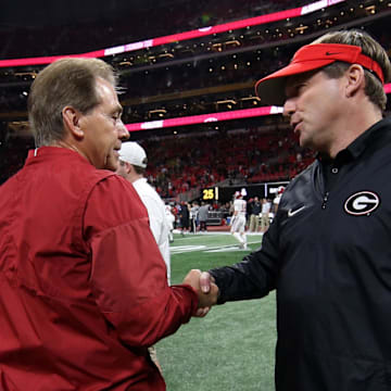 Former Alabama Crimson Tide head coach Nick Saban shakes hands with Georgia Bulldogs head coach Kirby Smart before the 2018 CFP national championship college football game at Mercedes-Benz Stadium. 