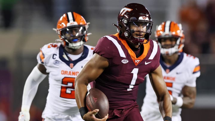 Oct 26, 2023; Blacksburg, Virginia, USA; Virginia Tech Hokies quarterback Kyron Drones (1) runs the ball against Syracuse Orange linebacker Marlowe Wax (2) during the second quarter at Lane Stadium. Mandatory Credit: Peter Casey-USA TODAY Sports