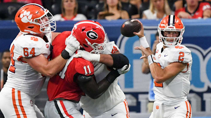 Aug 31, 2024; Atlanta, Georgia, USA; Clemson Tigers quarterback Cade Klubnik (2) throws a pass as lineman Walker Parks (64) and offensive lineman Marcus Tate (74) block Georgia Bulldogs linebacker Jalon Walker (11) during the first quarter of the 2024 Aflac Kickoff Game at Mercedes-Benz Stadium. Mandatory Credit: Ken Ruinard-Imagn Images