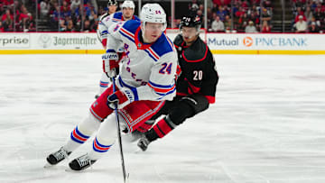 May 11, 2024; Raleigh, North Carolina, USA; New York Rangers right wing Kaapo Kakko (24) skates with the puck against Carolina Hurricanes center Sebastian Aho (20) during the second period in game four of the second round of the 2024 Stanley Cup Playoffs at PNC Arena. Mandatory Credit: James Guillory-Imagn Images