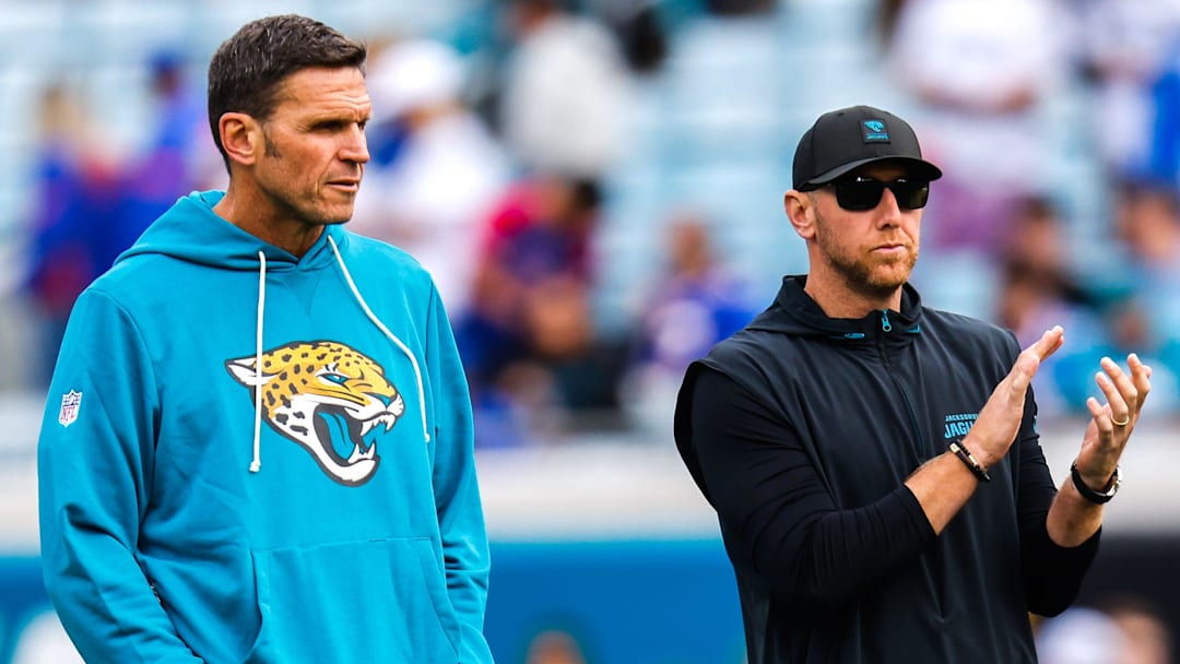 Jacksonville Jaguars Executive Vice President of Football Operations Tony Boselli, left and Jacksonville Jaguars head coach Liam Coen watch warm up before an NFL football AFC Wild Card playoff matchup, Sunday, Jan. 11, 2026, in Jacksonville, Fla. Bills lead 10-7 at the half over the Jaguars. [Doug Engle/Florida Times-Union]