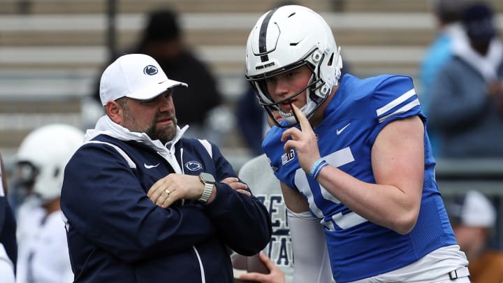 Penn State Nittany Lions quarterback Drew Allar (15) listens to offensive coordinator Andy Kotelnicki 