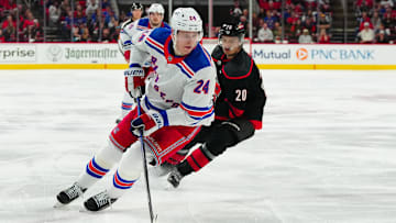 May 11, 2024; Raleigh, North Carolina, USA; New York Rangers right wing Kaapo Kakko (24) skates with the puck against Carolina Hurricanes center Sebastian Aho (20) during the second period in game four of the second round of the 2024 Stanley Cup Playoffs at PNC Arena. Mandatory Credit: James Guillory-USA TODAY Sports