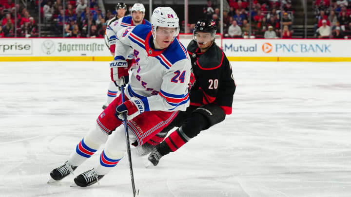 May 11, 2024; Raleigh, North Carolina, USA; New York Rangers right wing Kaapo Kakko (24) skates with the puck against Carolina Hurricanes center Sebastian Aho (20) during the second period in game four of the second round of the 2024 Stanley Cup Playoffs at PNC Arena. Mandatory Credit: James Guillory-USA TODAY Sports