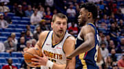 Nov 19, 2025; New Orleans, Louisiana, USA;  Denver Nuggets center Nikola Jokić (15) fights for position against New Orleans Pelicans center Yves Missi (21) during the first half at Smoothie King Center.
