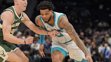 Feb 5, 2025; Charlotte, North Carolina, USA; Charlotte Hornets forward Miles Bridges (0) drives to the basket against Milwaukee Bucks guard AJ Green (20) during the second half at Spectrum Center. Mandatory Credit: Jim Dedmon-Imagn Images