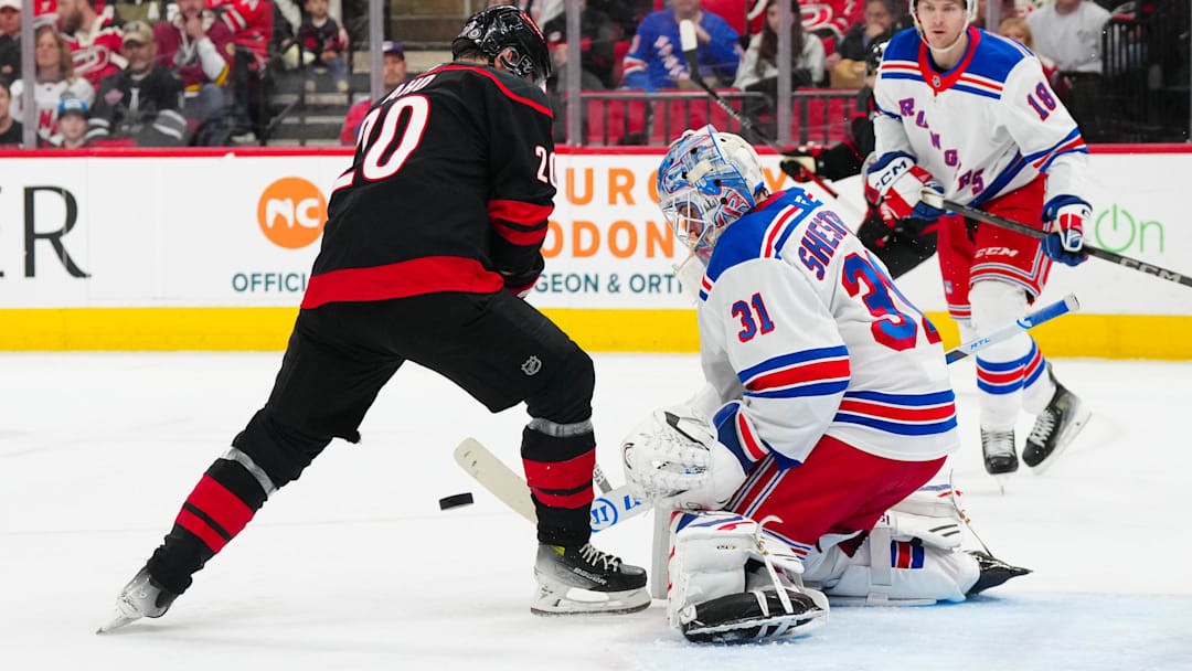Apr 12, 2025; Raleigh, North Carolina, USA;  New York Rangers goaltender Igor Shesterkin (31) stops the shot in front of Carolina Hurricanes center Sebastian Aho (20) during the first period at Lenovo Center. Mandatory Credit: James Guillory-Imagn Images