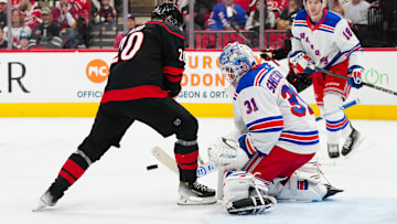 Apr 12, 2025; Raleigh, North Carolina, USA;  New York Rangers goaltender Igor Shesterkin (31) stops the shot in front of Carolina Hurricanes center Sebastian Aho (20) during the first period at Lenovo Center. Mandatory Credit: James Guillory-Imagn Images
