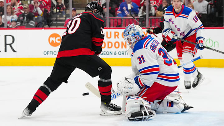 Apr 12, 2025; Raleigh, North Carolina, USA;  New York Rangers goaltender Igor Shesterkin (31) stops the shot in front of Carolina Hurricanes center Sebastian Aho (20) during the first period at Lenovo Center. Mandatory Credit: James Guillory-Imagn Images