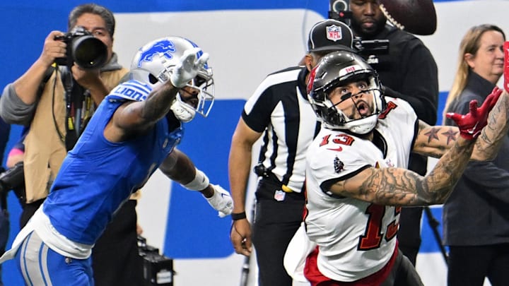 Jan 21, 2024; Detroit, Michigan, USA; Tampa Bay Buccaneers wide receiver Mike Evans (13) reaches for the ball against the Detroit Lions during the first half in a 2024 NFC divisional round game at Ford Field. Mandatory Credit: Lon Horwedel-Imagn Images