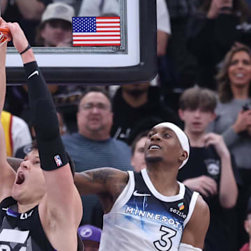 Feb 28, 2025; Salt Lake City, Utah, USA; Utah Jazz center Walker Kessler (24) dunks against Minnesota Timberwolves forward Jaden McDaniels (3) during the last 10 seconds of the game at Delta Center. Mandatory Credit: Rob Gray-Imagn Images