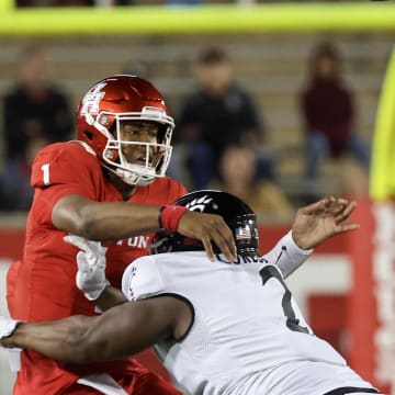 Nov 11, 2023; Houston, Texas, USA; Houston Cougars quarterback Donovan Smith (1) passes the all while being hit by Cincinnati Bearcats defensive lineman Dontay Corleone (2) in the second half at TDECU Stadium. Mandatory Credit: Thomas Shea-USA TODAY Sports