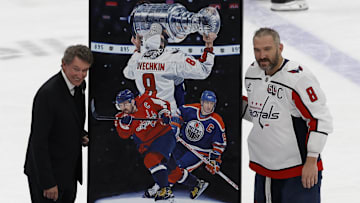 Apr 6, 2025; Elmont, New York, USA;  Washington Capitals left wing Alex Ovechkin (8) is honored with a painting by artist Tony Harris by former Canadian-American ice hockey player Wayne Gretzky after scoring in the during the second period against the New York Islanders at UBS Arena. Ovechkin scored the 895th goal of his career, breaking the NHL all-time career goals record previously held by Wayne Gretzky at UBS Arena. Mandatory Credit: Geoff Burke-Imagn Images