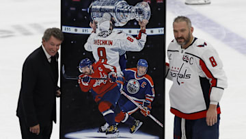 Apr 6, 2025; Elmont, New York, USA;  Washington Capitals left wing Alex Ovechkin (8) is honored with a painting by artist Tony Harris by former Canadian-American ice hockey player Wayne Gretzky after scoring in the during the second period against the New York Islanders at UBS Arena. Ovechkin scored the 895th goal of his career, breaking the NHL all-time career goals record previously held by Wayne Gretzky at UBS Arena. Mandatory Credit: Geoff Burke-Imagn Images