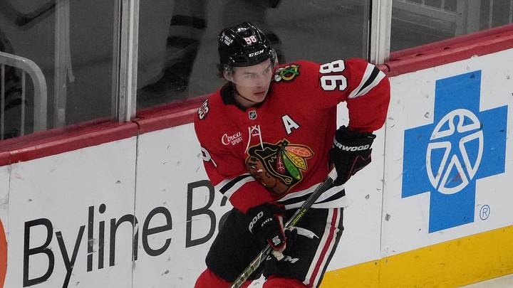 Apr 15, 2026; Chicago, Illinois, USA; Chicago Blackhawks center Connor Bedard (98) grabs the puck against the San Jose Sharks during the first period at United Center. Mandatory Credit: David Banks-Imagn Images