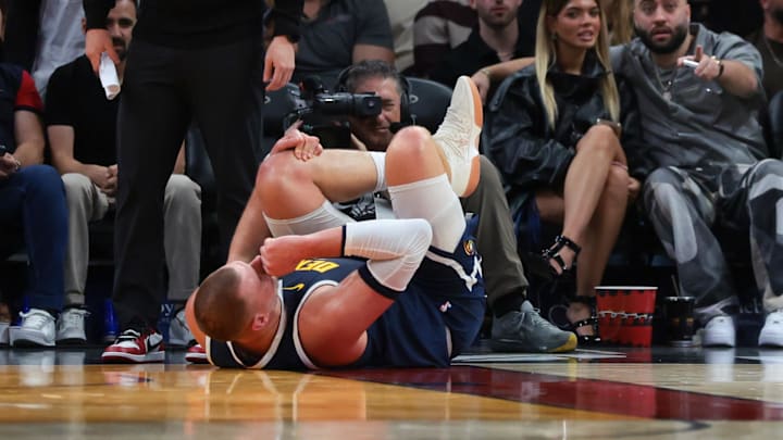 Nikola Jokic suffered a left knee injury against the Heat. Nikola Jokic suffered a left knee injury against the Heat.