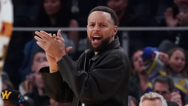 Feb 22, 2026; San Francisco, California, USA;  Golden State Warriors guard Stephen Curry (30) cheers from the bench during a game against the Denver Nuggets in the third quarter at Chase Center. Mandatory Credit: David Gonzales-Imagn Images