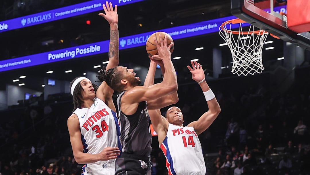 Brooklyn Nets forward Tosan Evbuomwan (12) looks to drive past Detroit Pistons forward Bobi Klintman (34) and guard Wendell Moore Jr. (14) in the fourth quarter at Barclays Center.