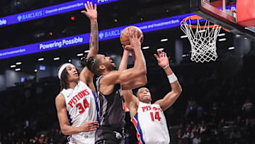 Brooklyn Nets forward Tosan Evbuomwan (12) looks to drive past Detroit Pistons forward Bobi Klintman (34) and guard Wendell Moore Jr. (14) in the fourth quarter at Barclays Center.