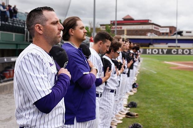 Holy Cross baseball coach Ed Kahovec stands for the National Anthem before facing Army.