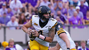 Sep 14, 2024; Greenville, North Carolina, USA;  Appalachian State Mountaineers quarterback Joey Aguilar (4) rolls out of the pocket against the East Carolina Pirates during the first half at Dowdy-Ficklen Stadium. Mandatory Credit: James Guillory-Imagn Images