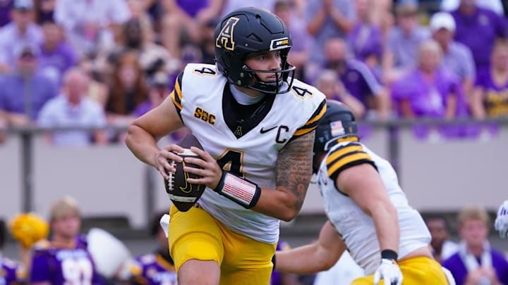 Sep 14, 2024; Greenville, North Carolina, USA;  Appalachian State Mountaineers quarterback Joey Aguilar (4) rolls out of the pocket against the East Carolina Pirates during the first half at Dowdy-Ficklen Stadium. Mandatory Credit: James Guillory-Imagn Images