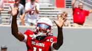 Sep 6, 2025; Raleigh, North Carolina, USA; North Carolina State Wolfpack quarterback CJ Bailey (11) celebrates a touchdown with fans during the first half of the game against Virginia Cavaliers at Carter-Finley Stadium. Mandatory Credit: Jaylynn Nash-Imagn Images