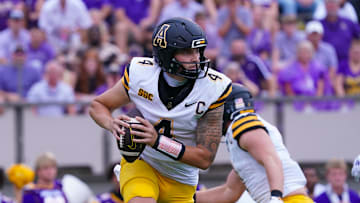 Sep 14, 2024; Greenville, North Carolina, USA;  Appalachian State Mountaineers quarterback Joey Aguilar (4) rolls out of the pocket against the East Carolina Pirates during the first half at Dowdy-Ficklen Stadium. Mandatory Credit: James Guillory-Imagn Images