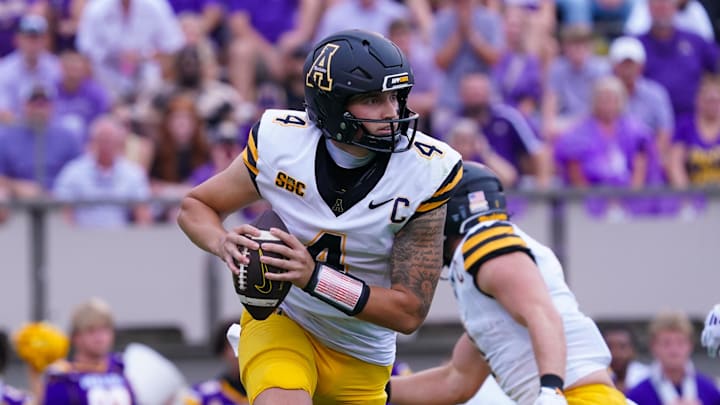 Sep 14, 2024; Greenville, North Carolina, USA;  Appalachian State Mountaineers quarterback Joey Aguilar (4) rolls out of the pocket against the East Carolina Pirates during the first half at Dowdy-Ficklen Stadium. Mandatory Credit: James Guillory-Imagn Images
