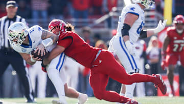 Louisville Cardinals defensive lineman Ashton Gillotte (9) brings down Kentucky Wildcats quarterback Devin Leary (13) for a sack in the first half Saturday. Nov. 25, 2023.