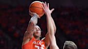 Feb 25, 2025; Champaign, Illinois, USA;  Illinois Fighting Illini guard Tre White (22) shoot s the ball over Iowa Hawkeyes forward Pryce Sandfort (24) during the first half at State Farm Center. Mandatory Credit: Ron Johnson-Imagn Images