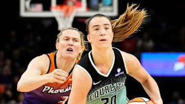 New York Liberty guard Sabrina Ionescu (20) controls the ball against Phoenix Mercury guard Sami Whitcomb (33) in overtime during Game One of the 2025 WNBA Playoffs first round at PHX Arena on Sept. 14, 2025.