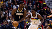 Dec 28, 2022; New Orleans, Louisiana, USA; New Orleans Pelicans forward Zion Williamson (1) looks to pass against Minnesota Timberwolves guard Anthony Edwards (1) during the second half at Smoothie King Center. 