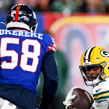 Green Bay Packers wide receiver Romeo Doubs (87) runs the ball against New York Giants linebacker Bobby Okereke.