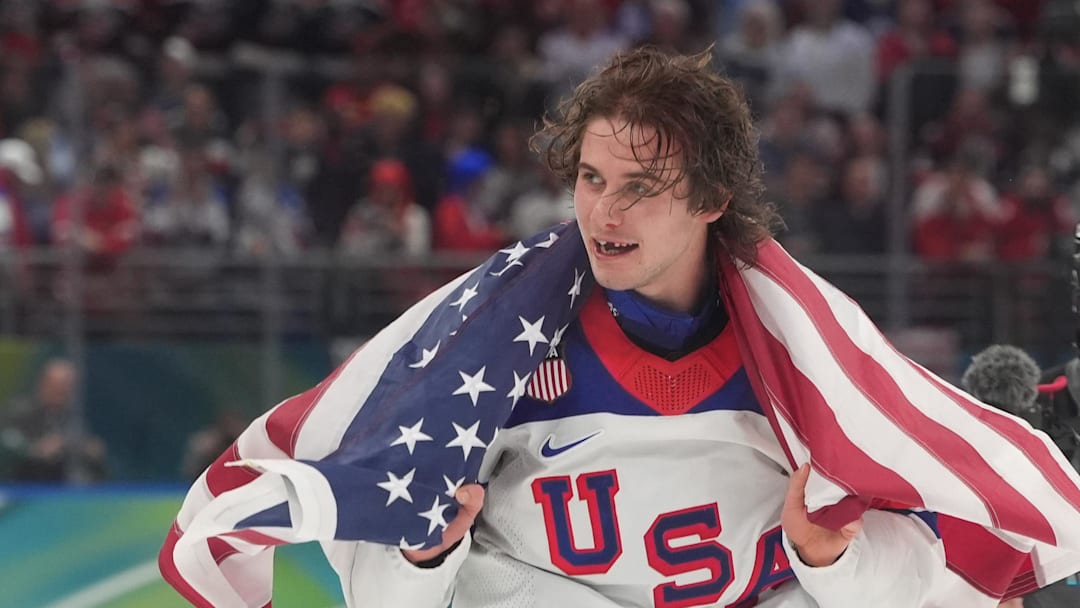 Feb 22, 2026; Milan, Italy; Jack Hughes (86) of the United States celebrates after defeating Canada in the men's ice hockey gold medal game during the Milano Cortina 2026 Olympic Winter Games at Milano Santagiulia Ice Hockey Arena. Mandatory Credit: Amber Searls-Imagn Images
