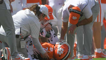 Sep 21, 2024; Clemson, South Carolina, USA; Clemson Tigers running back Phil Mafah (7) is examined by trainers and head coach Dabo Swinney after suffering an apparent injury against the North Carolina State Wolfpack during the first quarter at Memorial Stadium. Mandatory Credit: Ken Ruinard-Imagn Images