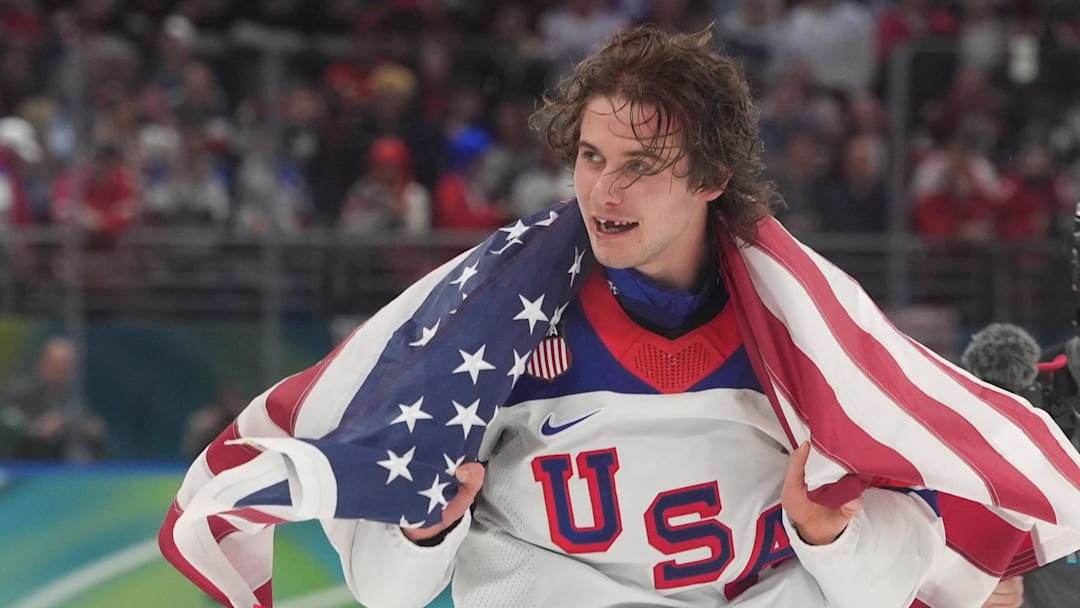 Feb 22, 2026; Milan, Italy; Jack Hughes (86) of the United States celebrates after defeating Canada in the men's ice hockey gold medal game during the Milano Cortina 2026 Olympic Winter Games at Milano Santagiulia Ice Hockey Arena. Mandatory Credit: Amber Searls-Imagn Images