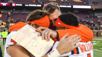 Nov 4, 2023; Minneapolis, Minnesota, USA; Illinois Fighting Illini head coach Bret Bielema hugs quarterback John Paddock (4) and wide receiver Isaiah Williams (1) after defeating the Minnesota Golden Gophers at Huntington Bank Stadium. Mandatory Credit: Matt Krohn-USA TODAY Sports