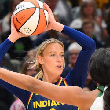 Aug 3, 2025; Seattle, Washington, USA; Indiana Fever guard Sophie Cunningham (8) looks to pass the ball against the Seattle Storm during the first half at Climate Pledge Arena. Mandatory Credit: Steven Bisig-Imagn Images