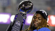 Ashton Jeanty hoists the Mountain West trophy. 