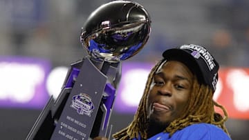 Boise State Broncos running back Ashton Jeanty (2) hoists the Mountain West Trophy.