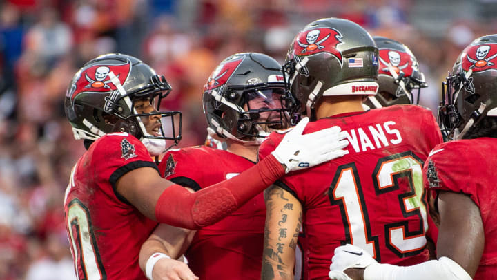 Dec 24, 2023; Tampa, Florida, USA; Tampa Bay Buccaneers quarterback Baker Mayfield (6) and wide receiver Mike Evans (13) celebrate a touchdown against the Jacksonville Jaguars in the second quarter at Raymond James Stadium. Mandatory Credit: Jeremy Reper-USA TODAY Sports