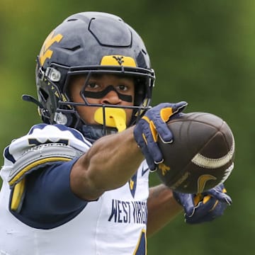 Sep 6, 2025; Athens, Ohio, USA; West Virginia Mountaineers wide receiver Cam Vaughn (4) celebrates a first down after a catch during the first quarter against the Ohio Bobcats at Peden Stadium. Mandatory Credit: Ben Queen-Imagn Images