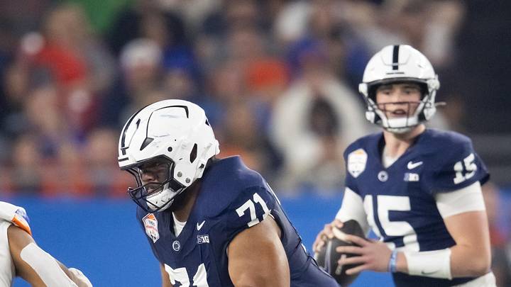Dec 31, 2024; Glendale, AZ, USA; Penn State Nittany Lions offensive lineman Olaivavega Ioane (71) blocks for quarterback Drew Allar (15) against the Boise State Broncos in the Fiesta Bowl at State Farm Stadium. Mandatory Credit: Mark J. Rebilas-Imagn Images
