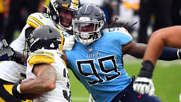 Oct 25, 2020; Nashville, Tennessee, USA; Tennessee Titans outside linebacker Jadeveon Clowney (99) tackles Pittsburgh Steelers running back James Conner (30) at Nissan Stadium. Mandatory Credit: Christopher Hanewinckel-Imagn Images