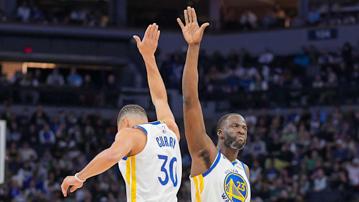  Golden State Warriors guard Stephen Curry (30) and forward Draymond Green (23) celebrate after a basket against the Minnesota Timberwolves in the second quarter at Target Center. Mandatory Credit: Brad Rempel-Imagn Images