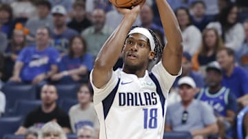 Apr 14, 2024; Oklahoma City, Oklahoma, USA; Dallas Mavericks forward Olivier-Maxence Prosper (18) shoots a three-point basket against the Oklahoma City Thunder during the first quarter at Paycom Center. Mandatory Credit: Alonzo Adams-Imagn Images