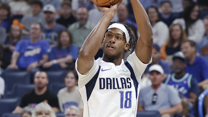 Apr 14, 2024; Oklahoma City, Oklahoma, USA; Dallas Mavericks forward Olivier-Maxence Prosper (18) shoots a three-point basket against the Oklahoma City Thunder during the first quarter at Paycom Center. Mandatory Credit: Alonzo Adams-Imagn Images