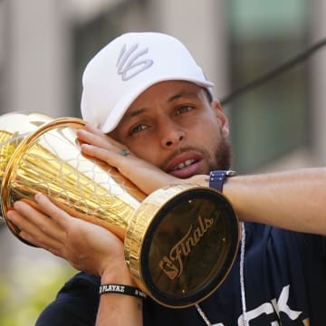 Jun 20, 2022; San Francisco, CA, USA; Golden State Warriors guard Stephen Curry poses with the NBA Finals Most Valuable Player Award trophy during the Warriors championship parade in downtown San Francisco. Mandatory Credit: Cary Edmondson-USA TODAY Sports